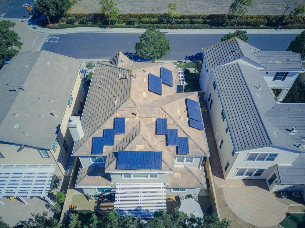 Aerial view of suburban roofs with solar panels