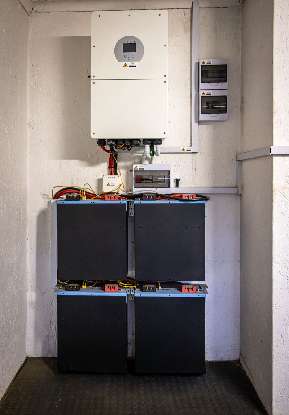 Home battery modules and inverter mounted on a garage wall